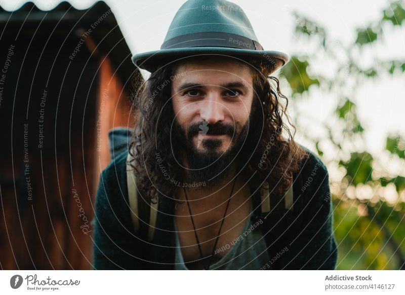 Smiling traveling man looking at camera hipster traveler portrait vacation tourist content beard smile style male nature carefree cheerful enjoy relax happy