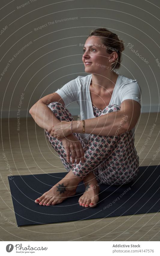 Smiling sportswoman resting after yoga lesson recreate training mat happy studio healthy smile wellness body female young sportswear cheerful vitality harmony