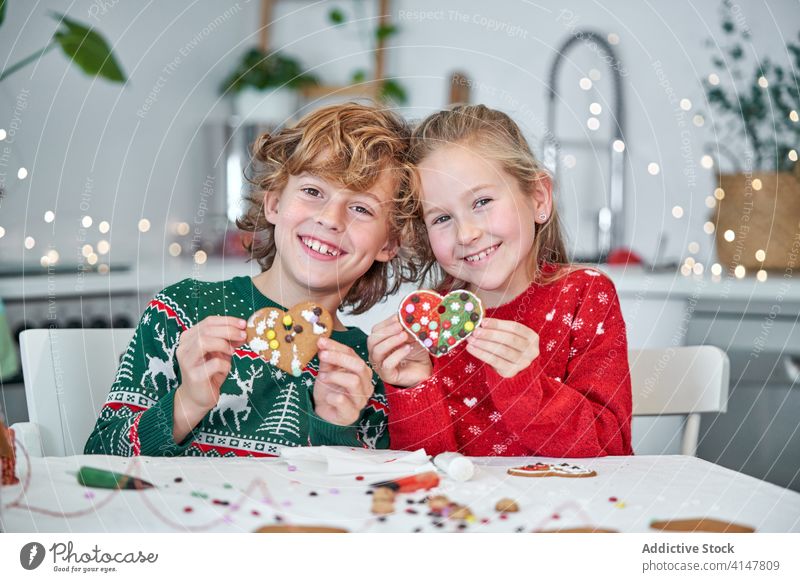 Cheerful siblings with heart shaped gingerbread cookie kid christmas happy prepare make together handmade holiday love relationship demonstrate children
