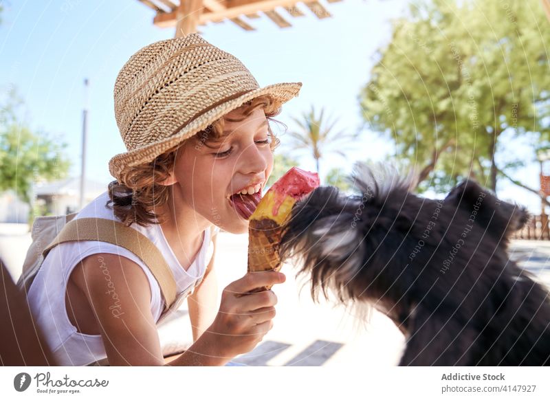 Cute little boy sharing ice cream with dog sweet dessert fun kid summer lick vacation child eat relax cute rest pet tasty together delicious weekend young