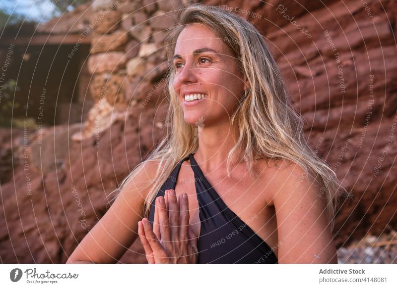 Portrait of a blonde woman in a swimsuit meditating on a beach yoga meditation nature fitness relaxation health female wellness practice wellbeing healthy