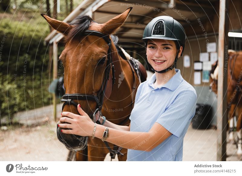 Delighted female equestrians with chestnut horse woman horsewoman ranch together jockey countryside cheerful rider animal uniform bridle reins equipment equine