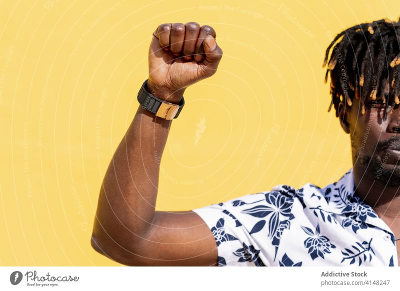 handsome young black man with raised fist person african right freedom activist life matter human protest arm fight demonstration revolution american riot