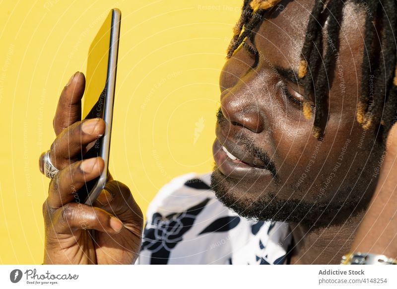 closeup of a black man recording a voice message communication phone portrait male person technology conversation using american mobile phone african smartphone