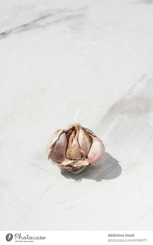 Garlic on marble table garlic condiment clove assorted seasoning natural food unpeeled ingredient cuisine cook culinary kitchen aroma flavor various recipe