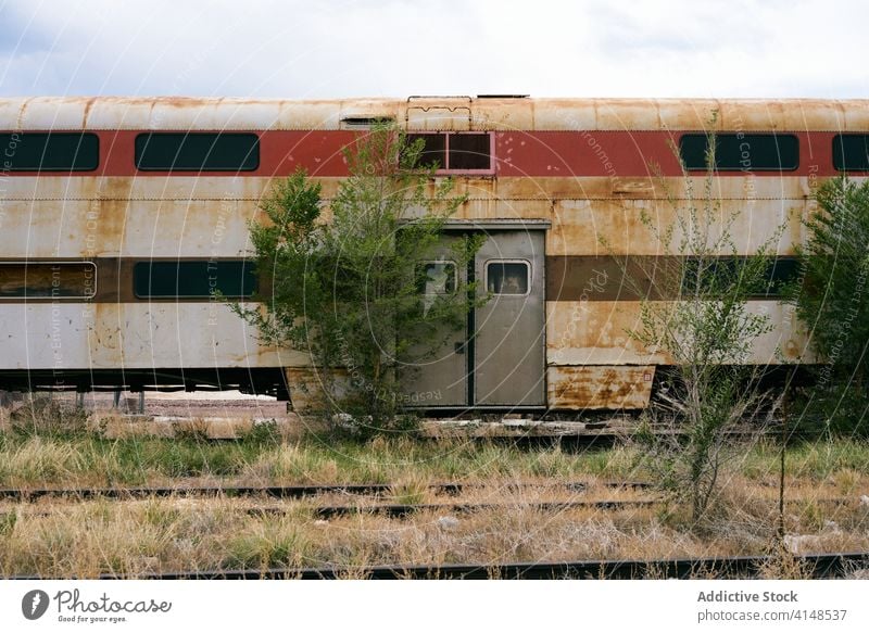 Shabby train on abandoned railway station forgotten railroad old shabby rust decay transport usa united states america facade metal overcast aged steel grunge