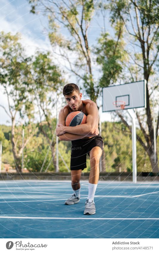 Sportsman with basketball on playground player training empty sunny summer sportsman male game athlete workout activity sportswear healthy exercise practice