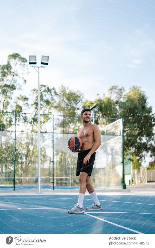 Male basketball player training on playground game man alone sportsman summer male energy healthy sporty muscular street urban sportswear concentrate exercise