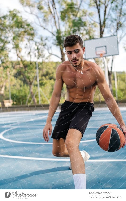 Male basketball player training on playground game man alone sportsman summer male energy healthy sporty muscular street urban sportswear concentrate exercise