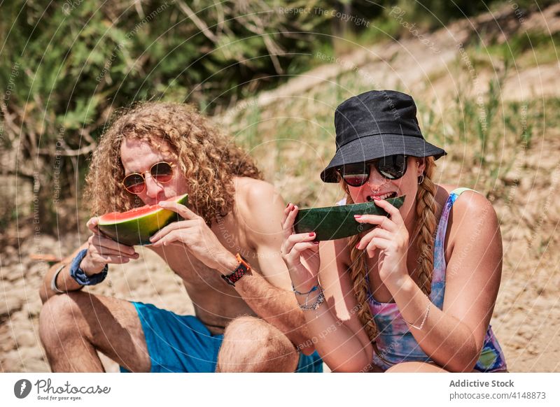 Couple eating watermelon in sunny day friend people together enjoy summer holiday sweet delicious forest tree log company group relax season chill friendship
