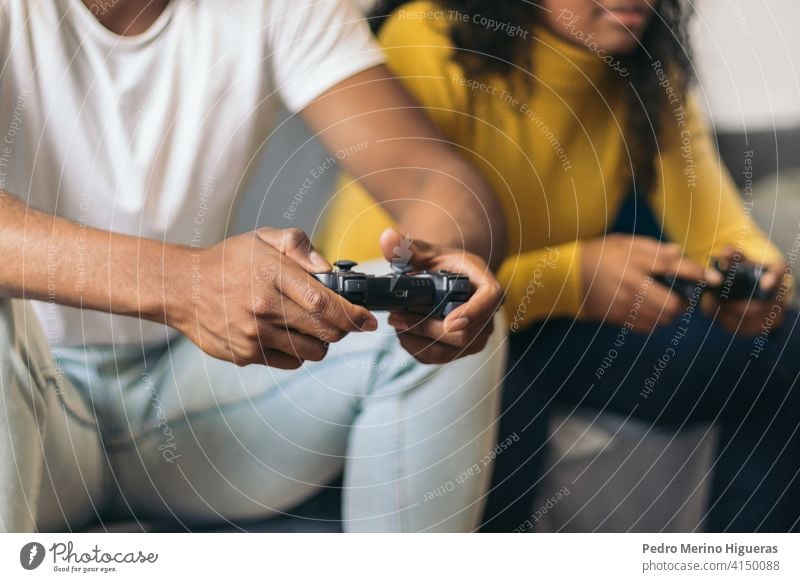 afro american couple playing video game at home. Close- up fun young happy together woman lifestyle family female sitting love girlfriend console people