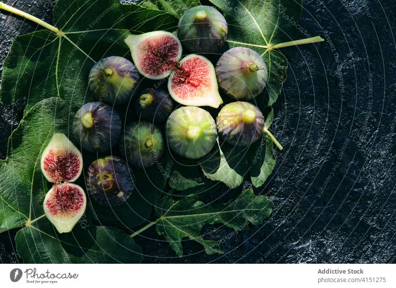 Fresh figs placed on top of green leaves fruit fresh natural food leaf organic vitamin veggie ripe delicious ingredient raw nutrition vegetarian vegan harvest