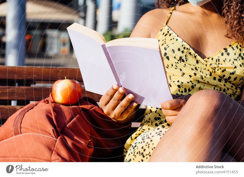 Black woman reading book on street thoughtful bookworm calm enjoy city weekend female ethnic black african american mask medical protect coronavirus outbreak