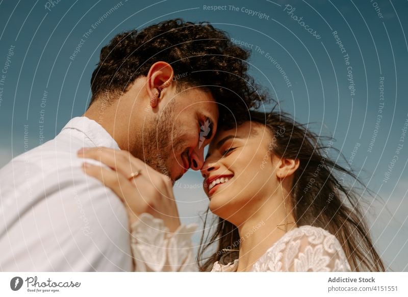 Affectionate newly married couple hugging and kissing - a Royalty Free  Stock Photo from Photocase
