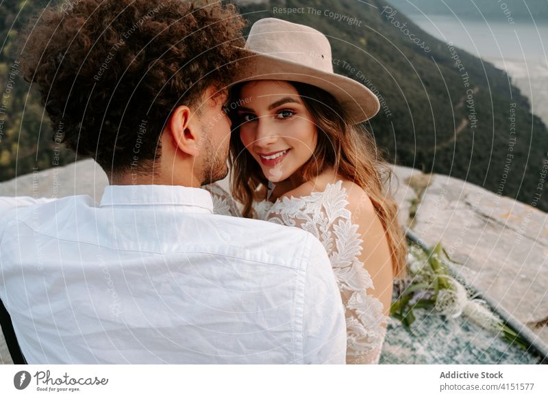Tender newlywed couple embracing each other in mountains romantic woman love young rock kiss happy nature together relationship wedding boho bride groom spain
