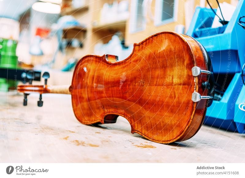Shiny violin on table in shop store workshop modern production shiny instrument bright melody sound contemporary design creative art style retail elegant simple