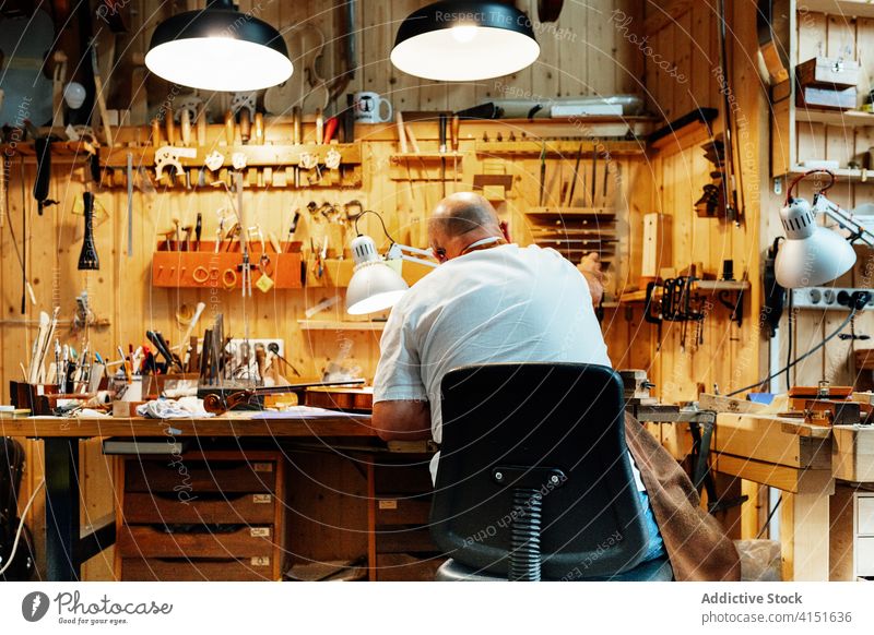 Craftsman working in modern workshop with tools craftsman artisan luthier repair make restore equipment skill master creative production handmade maker
