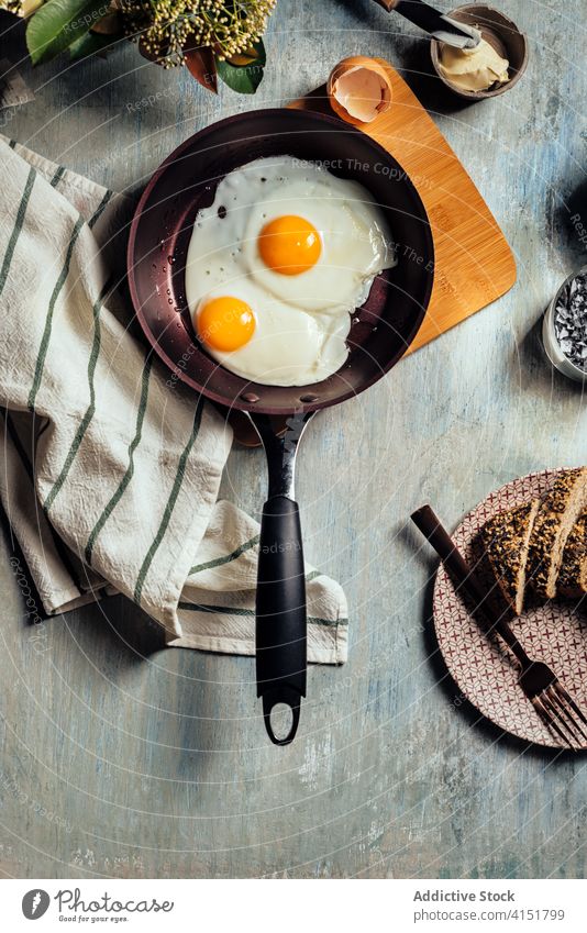 Fried egg. view of two fried eggs on a frying pan. breakfast protein cooking food cooked bread cholesterol plate meal hot yellow fat oil yolk diet fresh kitchen