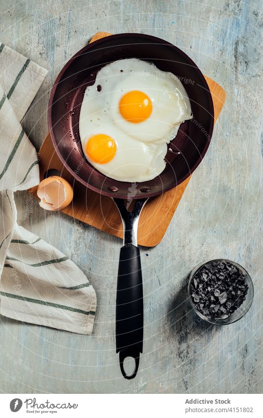 Fried egg. view of two fried eggs on a frying pan. breakfast protein cooking food cooked cholesterol plate meal hot yellow fat oil yolk diet fresh kitchen