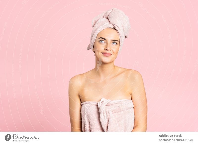Happy woman enjoying spa day beauty skin care happy towel bath wellness clean soft young female bare shoulders healthy smooth smile treat wellbeing lady fresh