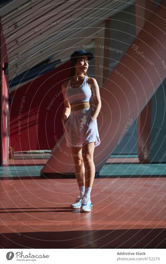 Calm Asian sportswoman on street athlete determine calm sportswear activewear slim fit female asian ethnic shorts bra workout training wellness activity