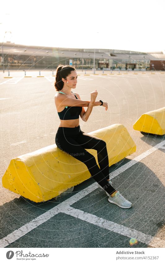 Sporty woman stretching before training sportswoman prepare runner sporty street fit athlete active young rest lifestyle break fitness workout sneakers exercise