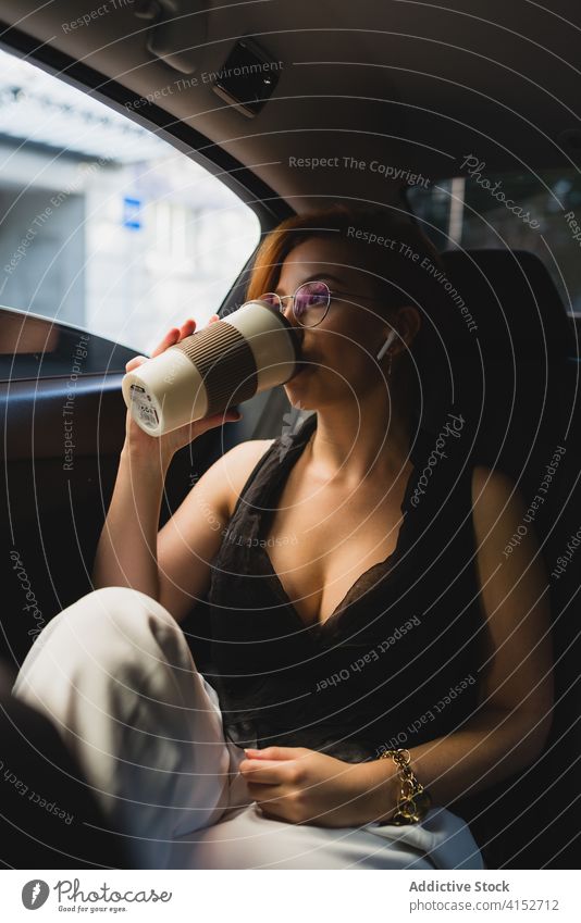 Businesswoman with coffee in car businesswoman commute work takeaway passenger entrepreneur manager female executive taxi luxury to go professional modern