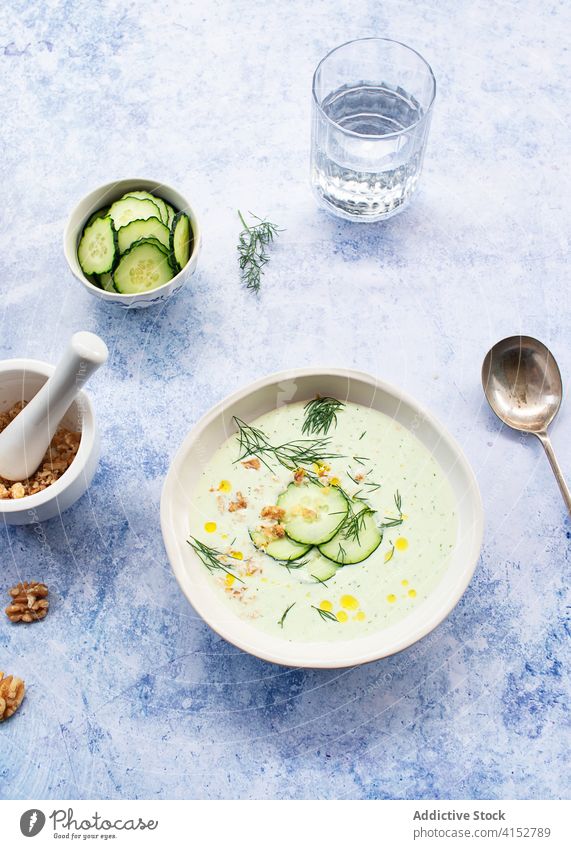 Cold cucumber and dill soup served on bowl delicious ingredients cooking cucumbers chilled refreshing spoon summer seasonal appetizer raw cold soup tasty