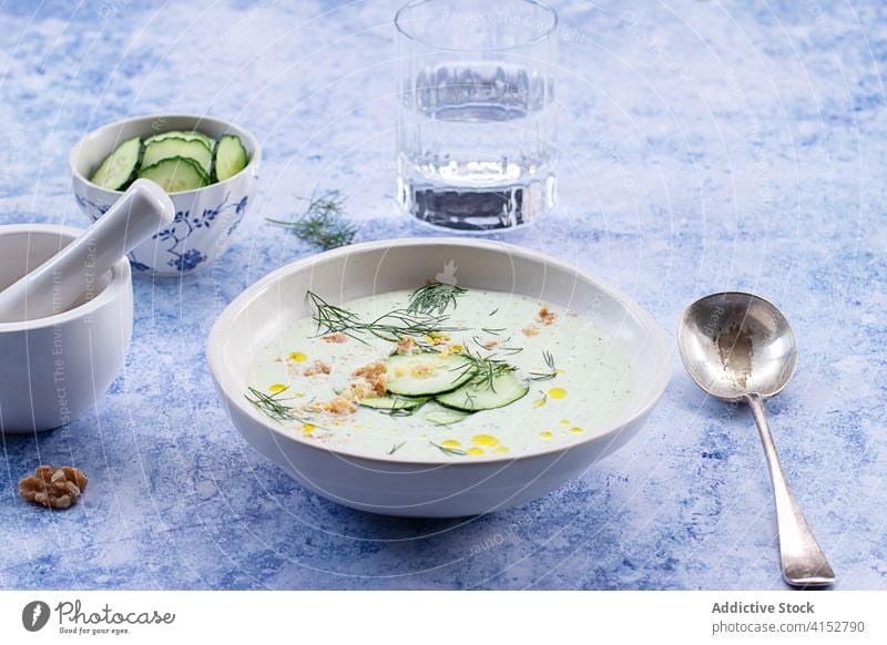 Cold cucumber and dill soup served on bowl delicious ingredients cooking cucumbers chilled refreshing spoon summer seasonal appetizer raw cold soup tasty