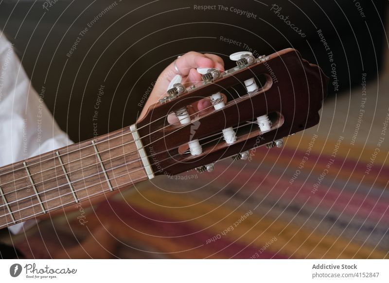 Detail of the hand of a girl tuning a guitar music tune artist audio inside finger musician perform melody musical player song practice sound string tone up