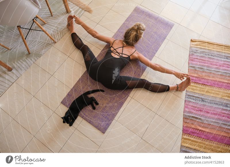 Aerial photo of a woman doing yoga while stretching in a house aerial drone wellbeing meditation mindfulness muscle gymnastics balance agility exercising