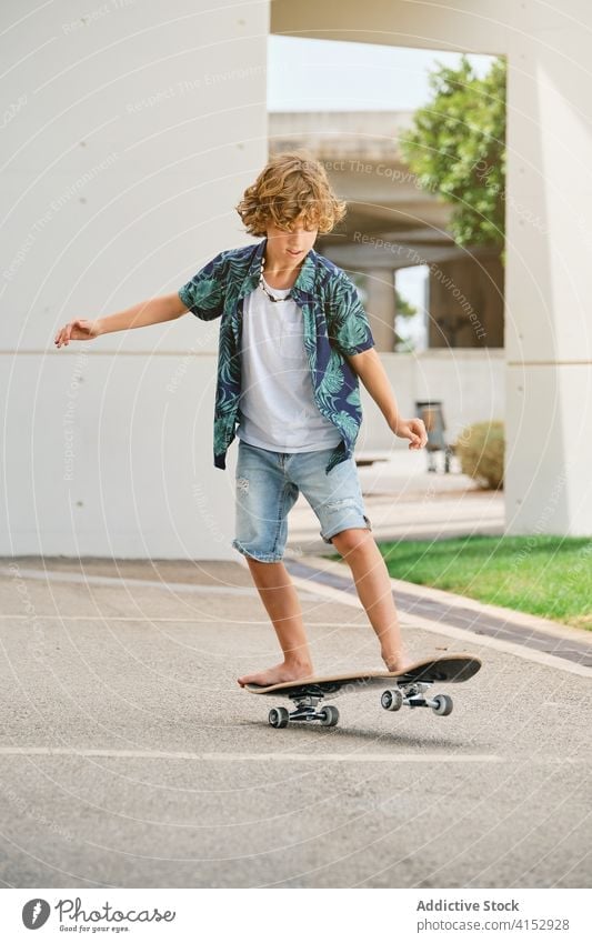 Boy in summer clothes skating a skateboard adolescence vitality jumping skill teenage attitude joyful teenager youth balance hipster agility dangerous