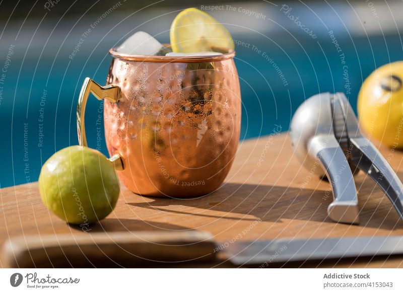 Moscow mule cocktail at poolside moscow mule drink alcohol lime ice cold copper cup squeeze beverage citrus refreshment fruit cool tasty lemon delicious gourmet
