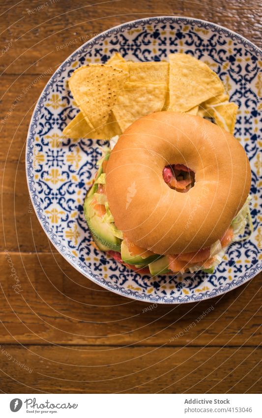 Delicious salmon bagel on plate in kitchen tasty delicious dish food meal cuisine lunch tomato tartar wooden table alioli beet pickle guacamole healthy