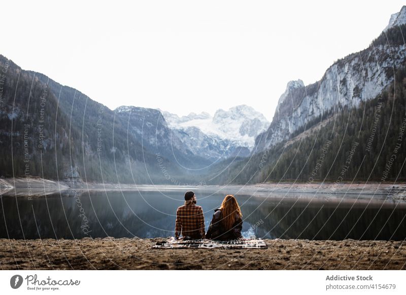 Travelling couple admiring mountain lake in autumn day shore landscape travel romantic relax peaceful recreation rock silent snow together tourism germany