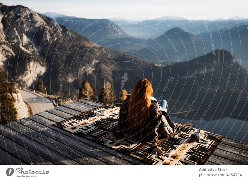 Traveling woman on wooden terrace in highlands viewpoint mountain morning traveler fog sunbeam tranquil enjoy female germany austria tourist scenery amazing