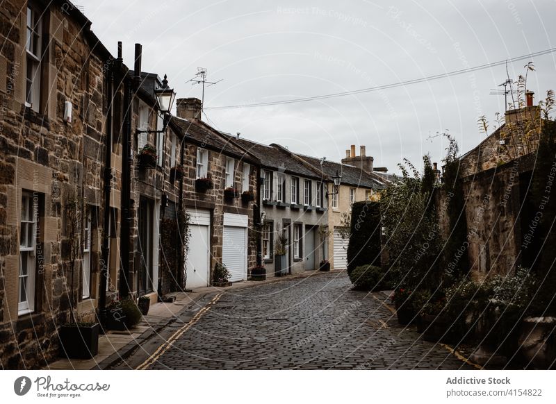 Narrow street with old buildings in town narrow grunge weathered gloomy cloudy architecture scottish highlands scotland uk united kingdom exterior residential