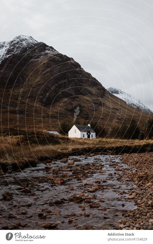 Lonely house in mountainous valley in autumn highland season lonely cold river residential scottish highlands scotland uk united kingdom range cottage calm gray