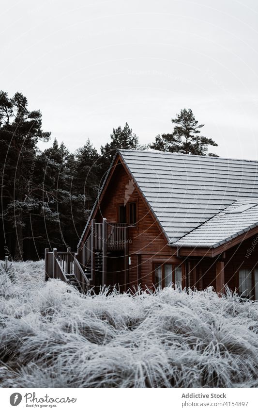Wooden cottage in countryside in winter residential house wooden village building snow season facade scottish highlands scotland uk united kingdom construction