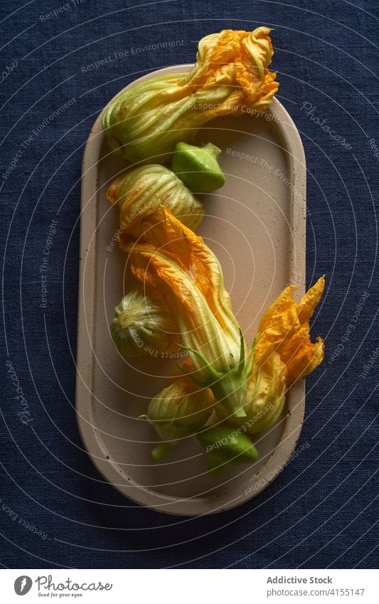Flat lay with zucchini flowers courgette squash vegetable yellow food fresh organic diet vegetarian orange raw healthy plant edible bud natural agriculture