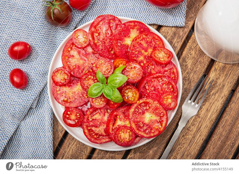 Top view of Tomato salad and basil leaves on plate. Mediterranean food tomato tomatoes cherry fresh cuisine diet dieting freshness healthy ingredient nature