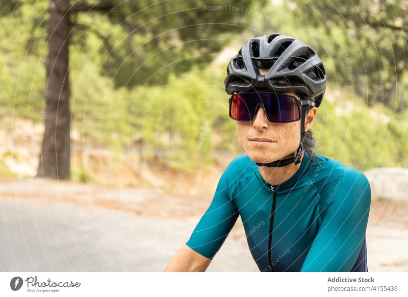 Woman road bike horizontal woman young adult mature woman driving sunset 40 years motion riding sport athlete athleticism color image cycling headwear