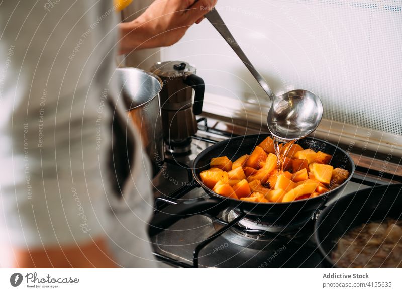 Housewife preparing pumpkin for soup cook prepare stew water pour vegetable ingredient food kitchen housewife add woman cuisine recipe culinary homemade