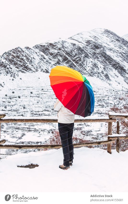Unrecognizable person under umbrella in mountains in winter colorful highland snow enjoy landscape wintertime pyrenees catalonia spain amazing bright white