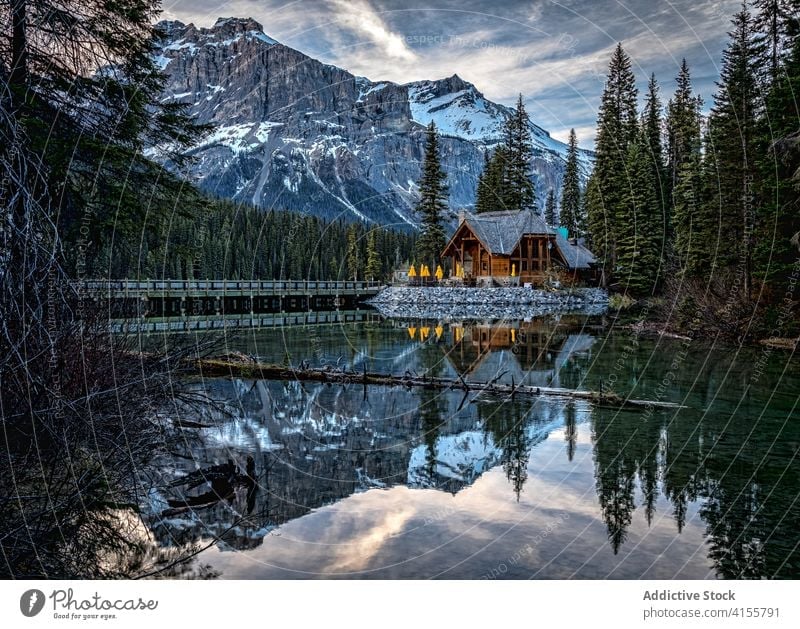 Wooden house near mountain lake in forest rock wild reflection landscape nature camp majestic cold picturesque scenic canada yoho national park emerald lake