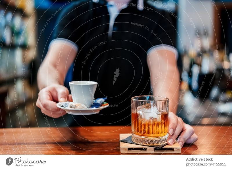 Crop bartender serving beverages in cafe serve barman counter coffee whiskey alcohol fresh service male glass cold cup pub refreshment booze scotch drink brew