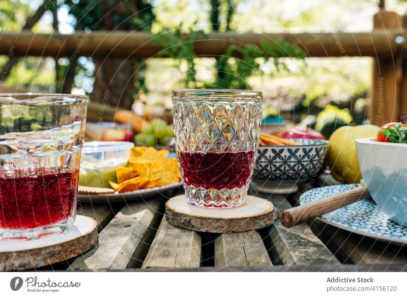 Sweet juice in glasses on table picnic beverage serve sweet delicious fruit forest nature valle del jerte caceres spain wooden various food organic nutrition