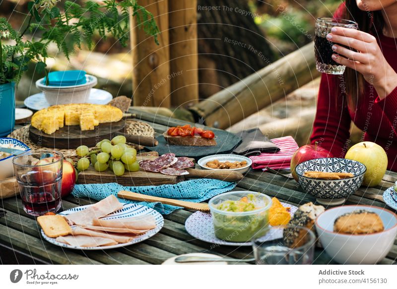 Crop women at table with food in forest picnic together eat various woods delicious valle del jerte caceres spain tasty wooden meal friend lunch vacation snack