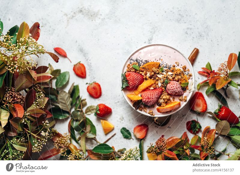 Healthy breakfast bowl with fruits on table smoothie bowl super food delicious nut nutrition healthy food raw food green plant muesli orange coconut various