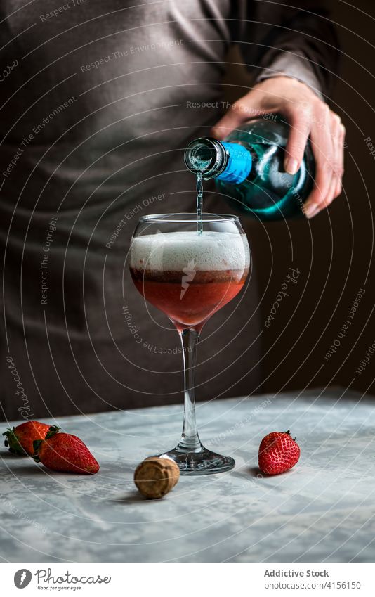 Crop woman pouring drink in glass alcohol beverage strawberry cocktail sweet table female delicious fresh prepare liquid tasty process ingredient fruit cold